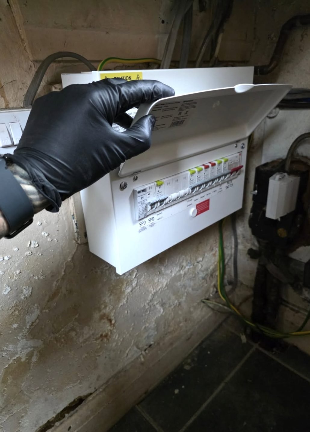 Electrician opening a newly installed consumer unit during testing