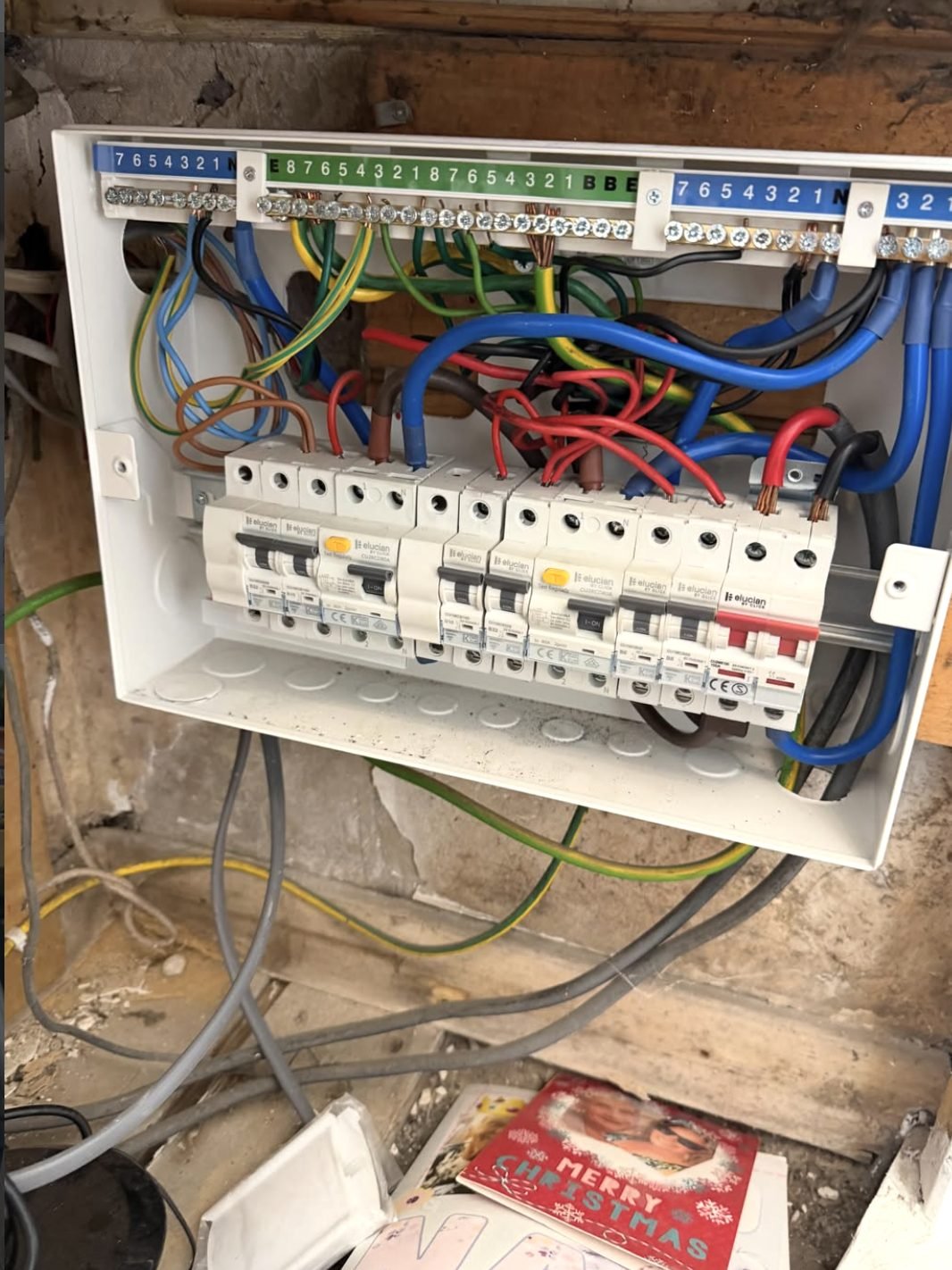 Consumer unit opened up showing existing circuit wiring during fault testing