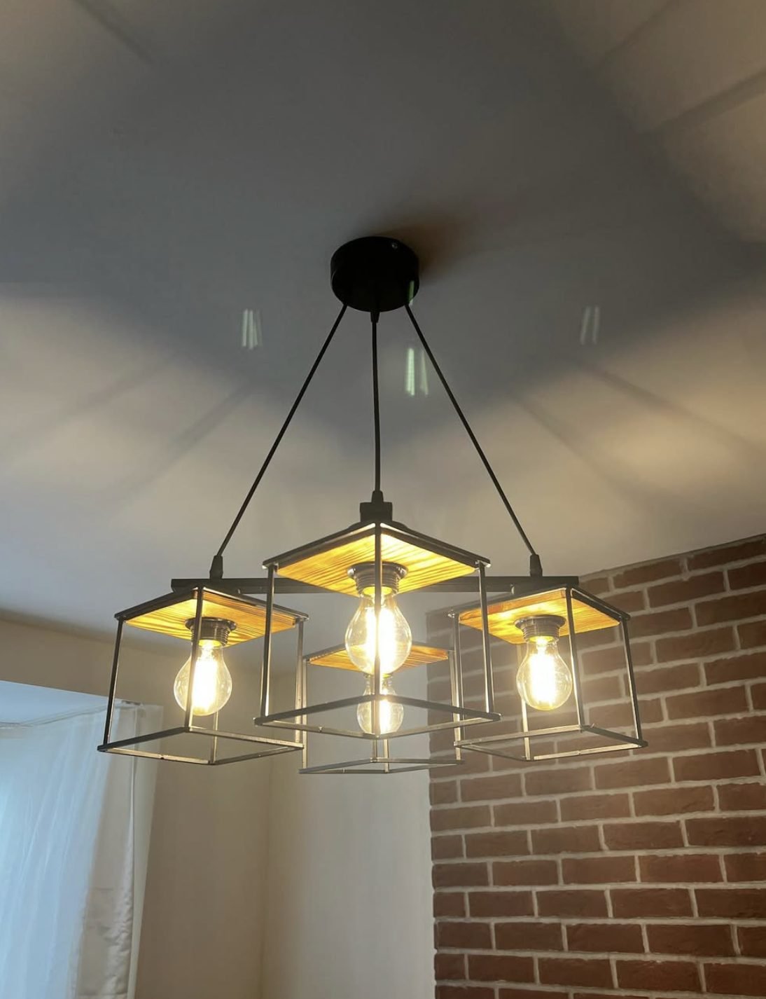 Four lantern industrial style pendant light fitted to a ceiling rose